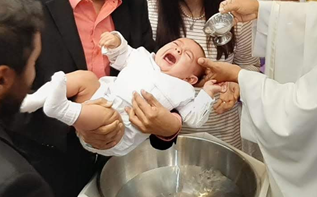 Child being baptized.