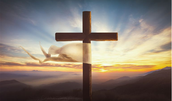 Cross during sunrise on a mountain